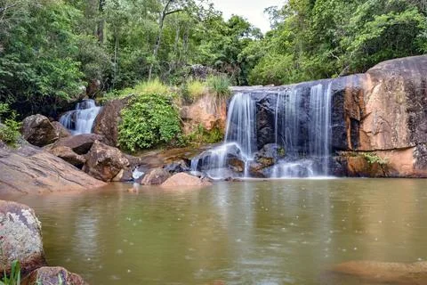 Waterfall and lake in rain forest of Moeda in Minas Gerais state on cloudy day Stock Photos