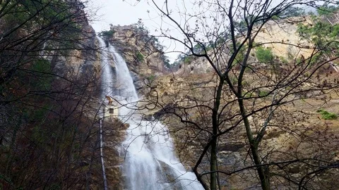 Waterfall and mountain stream in the autumn forest Stock Footage 84745339