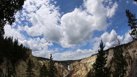 Waterfall and river flowing through canyon with soaring clouds. Stock Footage 71940554