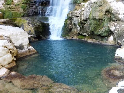 A waterfall and a small pool in the rocks. Oniore waterfall, Georgia Stock Photos