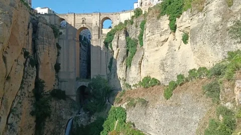 Waterfall and stone bridge with arches over the Guadalivin River, Ronda, Spain Stock Footage 344577664