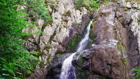 Waterfall and stone cliffs in the summer landscape. Stock Footage 203201413
