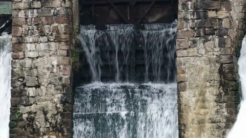 Waterfall in the autumn forest. Old micro hydro power plant Video stock 74012472