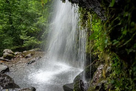 Waterfall from the back with rocks and moss Stock Photos