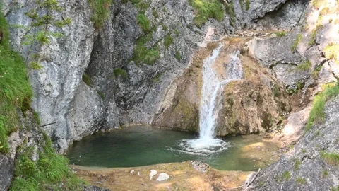 A waterfall with a beautiful pool in the mountains Video stock 217381858