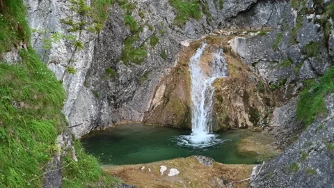 A waterfall with a beautiful pool in the mountains Video stock 217383573