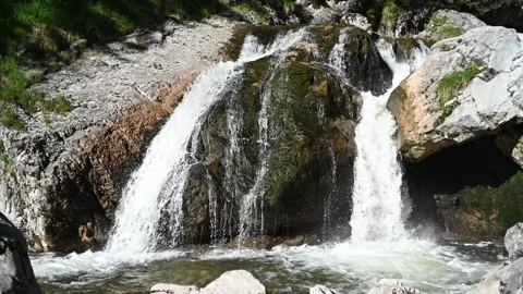 A waterfall with beautiful rocks in a forest (slow motion) 스톡 동영상 219351871