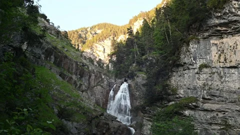 A waterfall with beautiful rocks in the mountains in the evening Stock-Footage 219355992