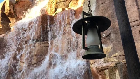 Waterfall behind a rustic lamp Stock Footage 113899762