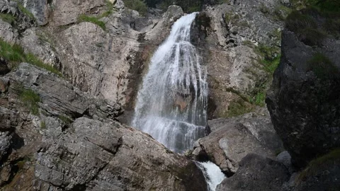 Waterfall between huge rocks in the mountains Stock-Footage 260826188