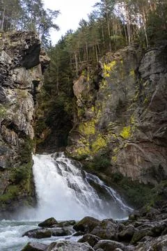 Waterfall between old rocks beautiful nature background Stock Photos