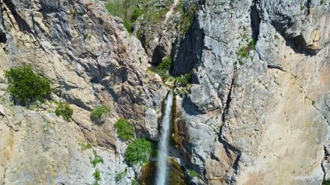Waterfall between Rocks Aerial Stock Footage 247957903