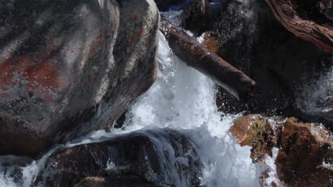 A Waterfall Between Rocks and Logs Stock Footage 251327772