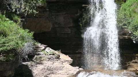 A waterfall between rocks and plants in summer Stock Footage 219418722