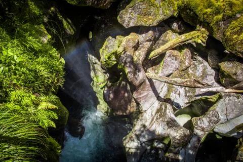 Waterfall between the rocks in the forest of New Zealand Stock Photos