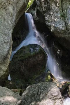 Waterfall between rocks in the mountain Stock Photos
