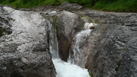 Waterfall between rocks from a mountain stream Stock Footage 211459306