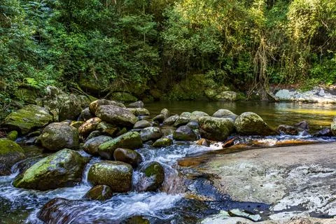 Waterfall between rocks in the rainforest Waterfall between rocks in the r... Фото