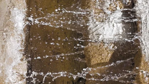 Waterfall on big rocks while the sun is shining Stock Footage 91182878