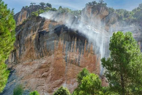 Waterfall blown by the wind on the path of the Borosa river Stock Photos