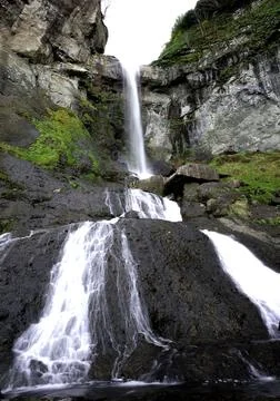 Waterfall in the bosom of the forest. Stock Photos