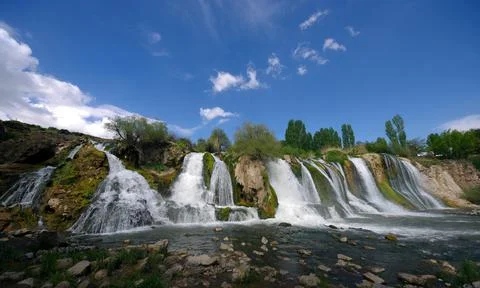 Waterfall in the bosom of the forest. Stock Photos