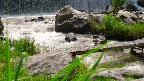 Waterfall bridge stone rock river flow green beautiful nature calm village Stock-Footage 265382946