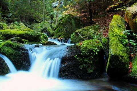 Waterfall - cascade in the autumn forest Stock Photos