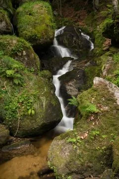 Waterfall, cascade between big rocks in ravine Ysperklamm Stock Photos