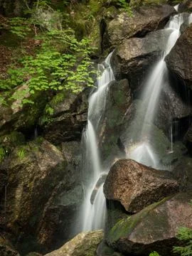 Waterfall, cascade between big rocks in ravine Ysperklamm Stock Photos