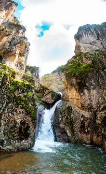 Waterfall cascade on mountain rocks. Stock Photos
