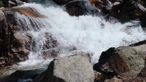 A Waterfall Cascades between Layers of Rocks Stock Footage 251331949