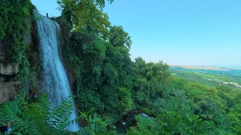 Waterfall cascades down forrest face. Edessa waterfalls Greece Stock Footage 344027609