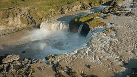 Waterfall cascades down rocky cliffs in stunning landscape Stock-Footage 320266237