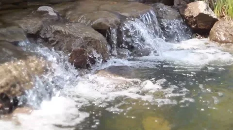 Waterfall cascades flowing over flat rocks Stock Footage 49734644
