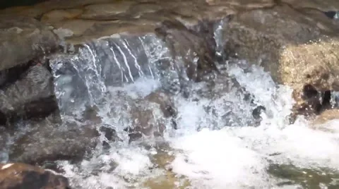 Waterfall cascades flowing over flat rocks Stock-Footage 49734655