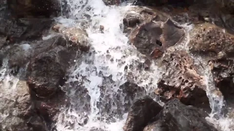 Waterfall cascades flowing over flat rocks Видео 49734662