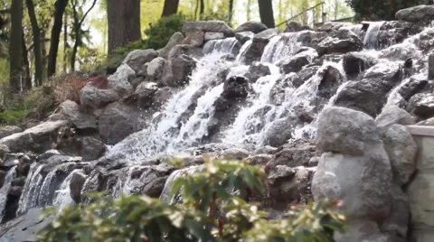 Waterfall cascades flowing over flat rocks Stock Footage 49734680
