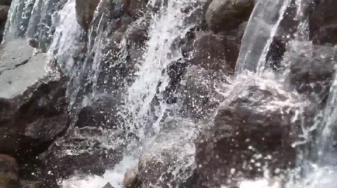 Waterfall cascades flowing over flat rocks Stock Footage 49734693