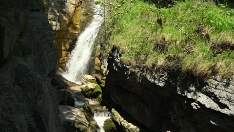 Waterfall cascades into a gorge Video stock 260813992