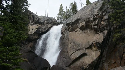 Waterfall Cascades Over Rocks in the Mountains Stock Footage 77198449