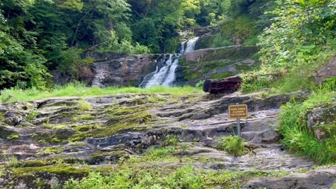 Waterfall Cascading Behind Closed Area Sign on Forest Rocks Stock Footage 344812072
