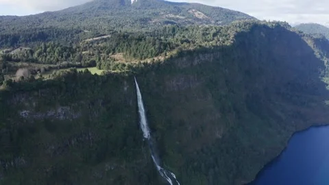 Waterfall Cascading from Cliff in Mountain Landscape Stock Footage 303603894