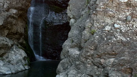 Waterfall cascading down granite wall Stock Footage 129537584