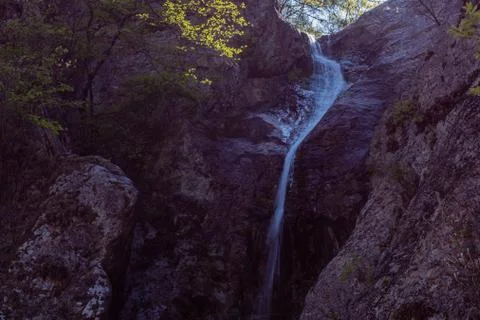 Waterfall cascading down granite wall Stock Photos
