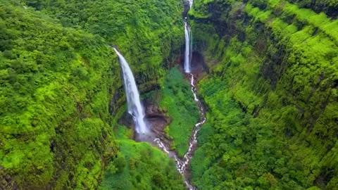 Waterfall cascading down from a high cliff (Aerial View) Stock Footage 282505820