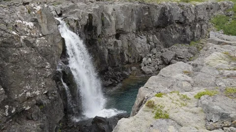 Waterfall Cascading Down Jagged Basalt Cliffs in Iceland 4K Nature Footage Stock Footage 339737700