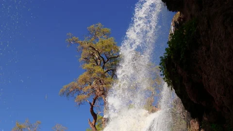 Waterfall cascading down the mountain creating rainbow 3 動画素材 148026969