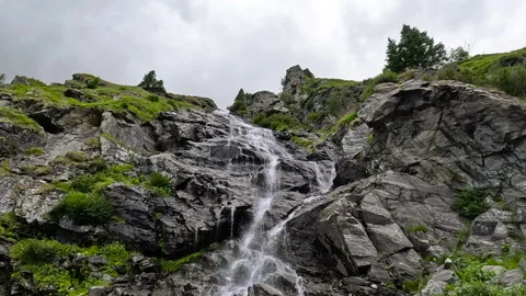 Waterfall cascading down a mountain Stock Footage 295894593