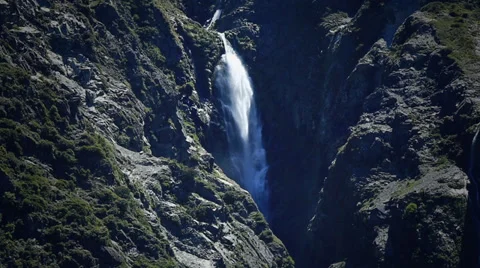 Waterfall cascading down from mountains, New Zealand. Stock Footage 34340899